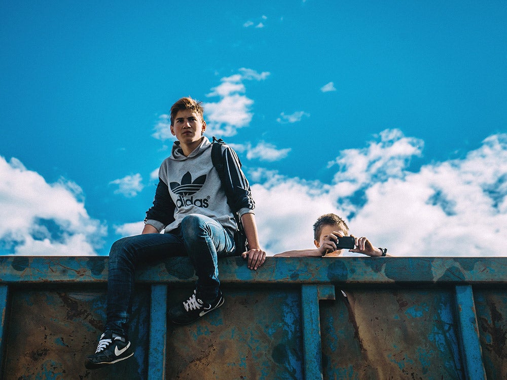 teens sitting on a wall