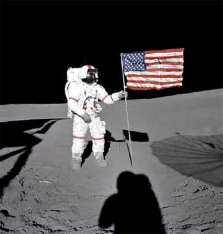 Al Shepard raises the American flag during Apollo 14