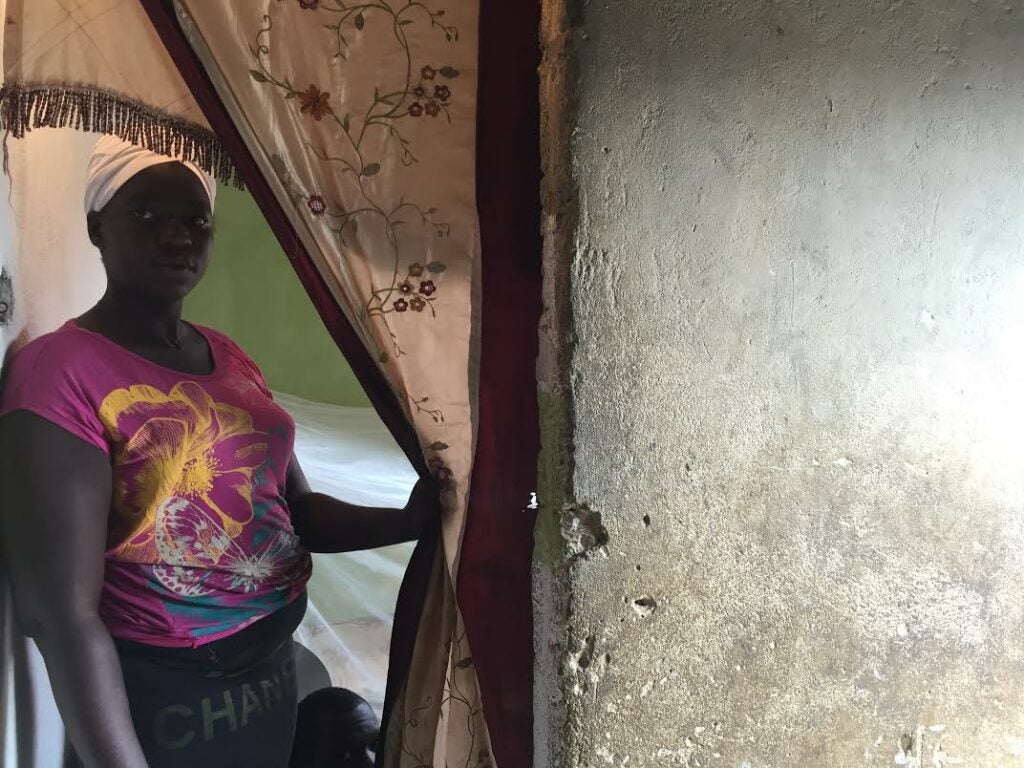 Calunga leans against a doorway in Luanda, Angola.
