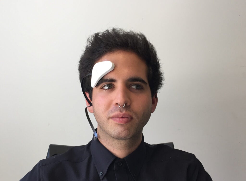 Man with tDCS electrode attached to his forehead.