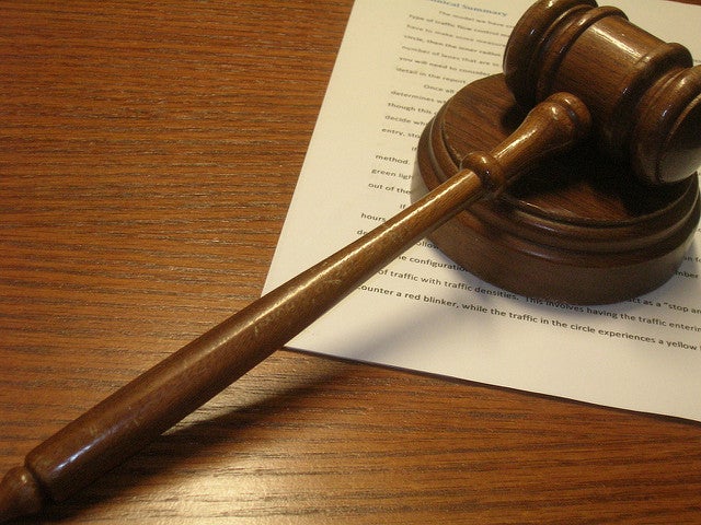 Gavel on op of legal document on table