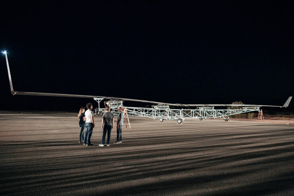 Mark Zuckerberg and others stand near Aquila, Facebook's internet drone.