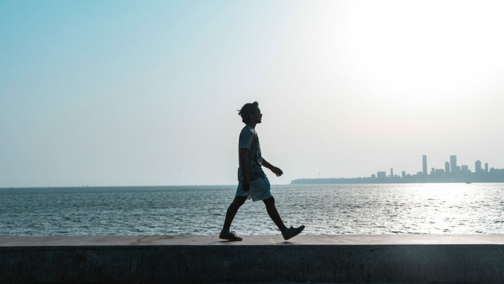 a person walking along the waterfront