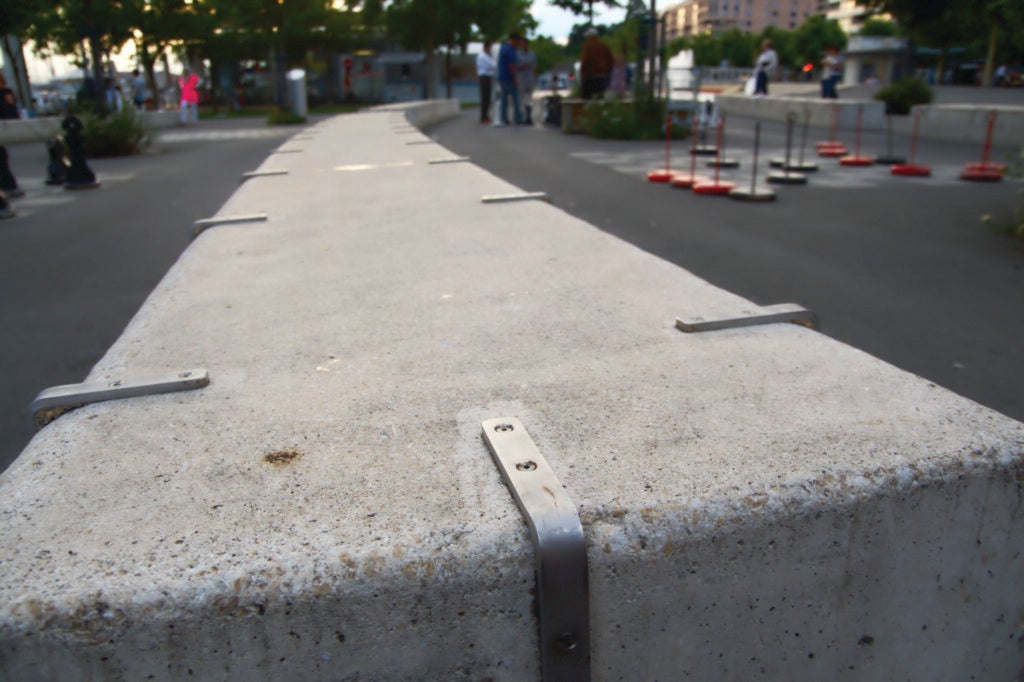 A low wall with metal anti-skate bars affixed along the edges.