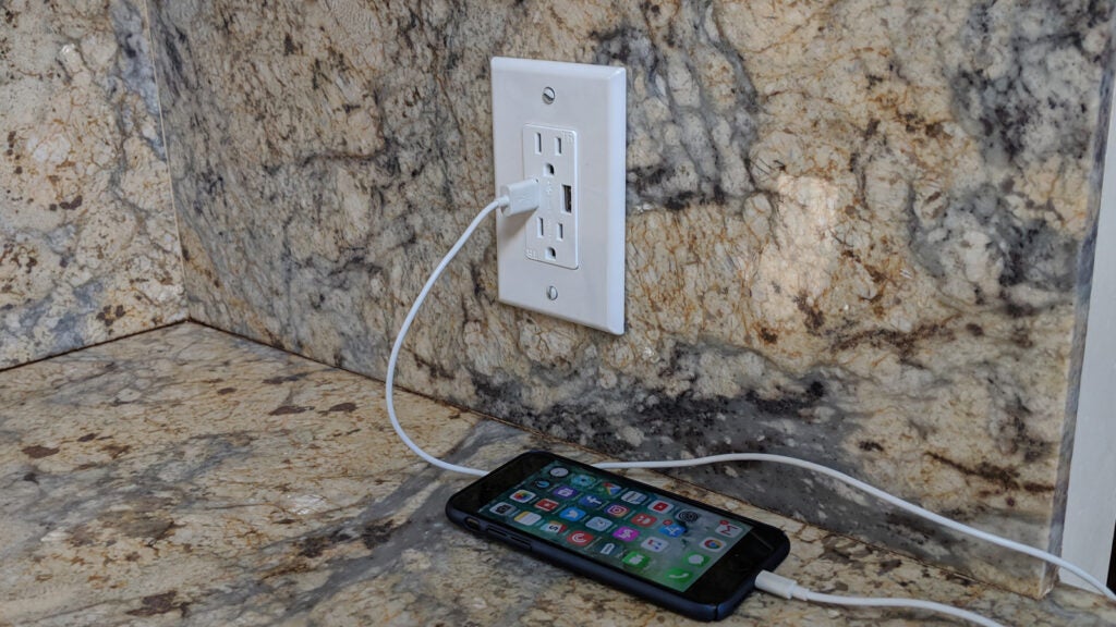 new USB outlet charging a smartphone