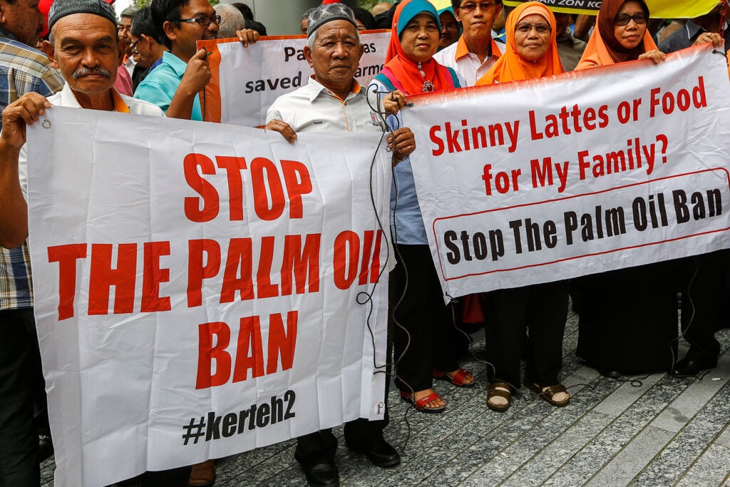 Protesters against the proposed EU ban in Kuala Lumpur with signs