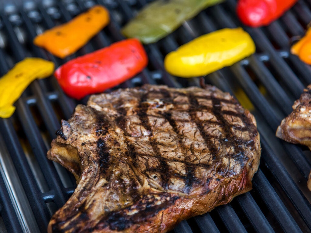 steak and peppers on the grill