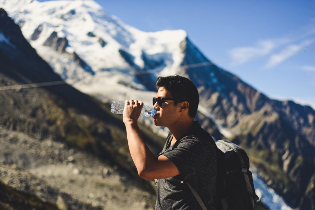 Man drinking water on a mountain