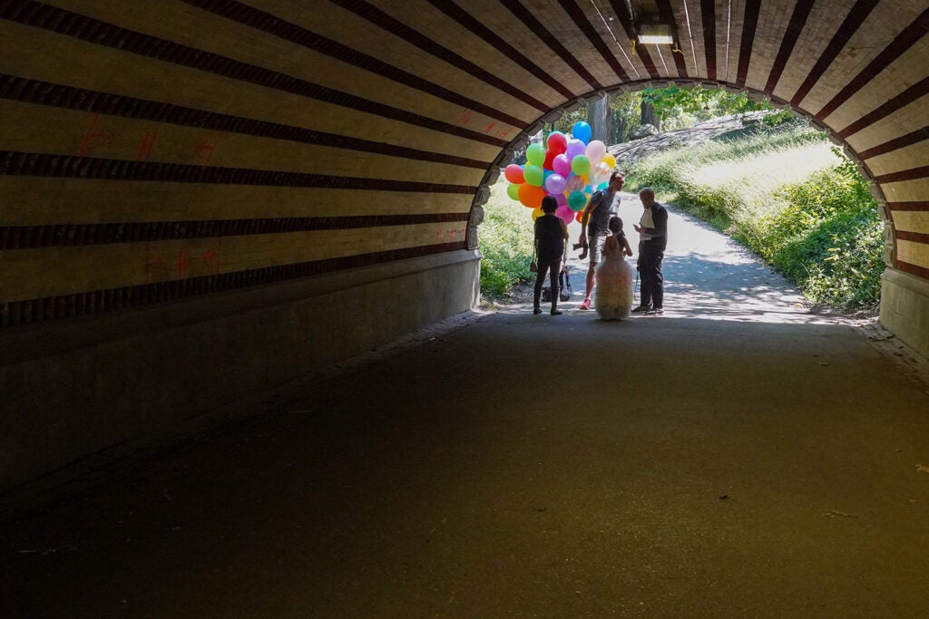 family with balloons at the end of a tunnel