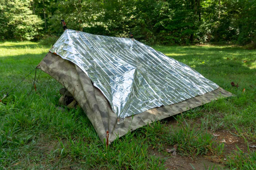 thermal blanket on topo of a lean-to shelter
