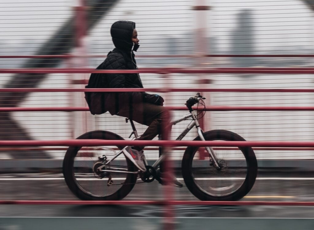 person riding a bike over a bridge