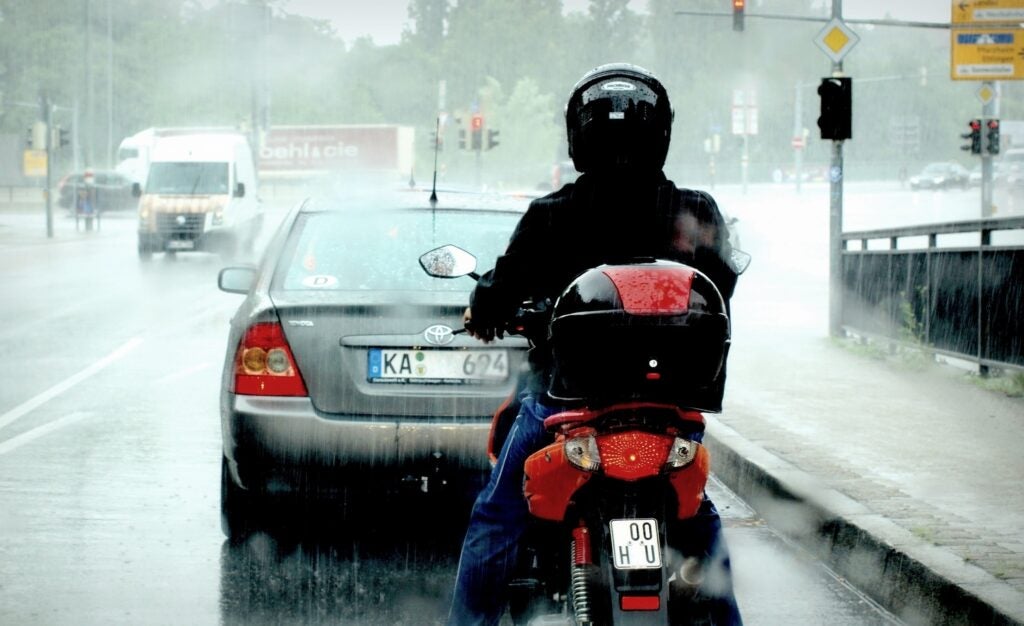motorcycle rearending a car in the rain