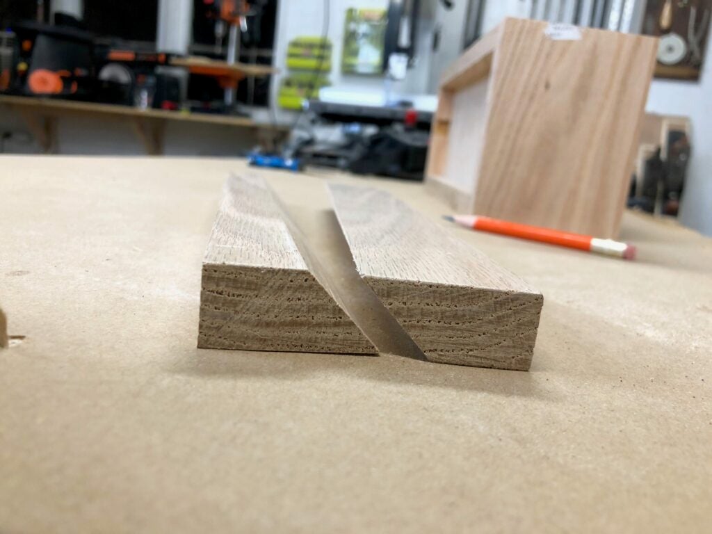 a piece of oak cut to form a French cleat
