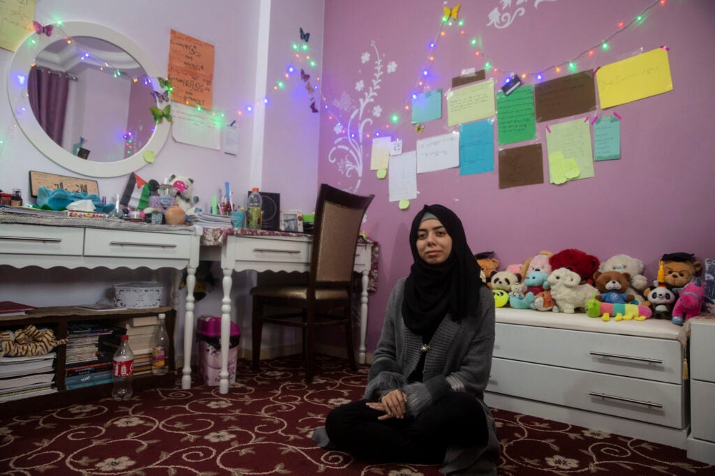 Mirna al-Sabbah, who dreams of becoming an astrophysicist, in her bedroom