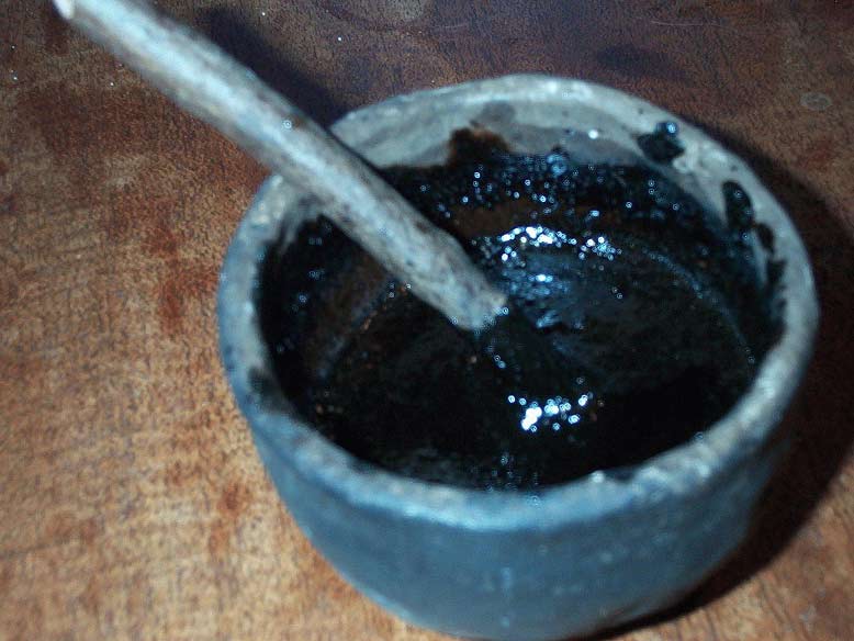 A bowl of hand-made pitch used to craft a homemade bow.