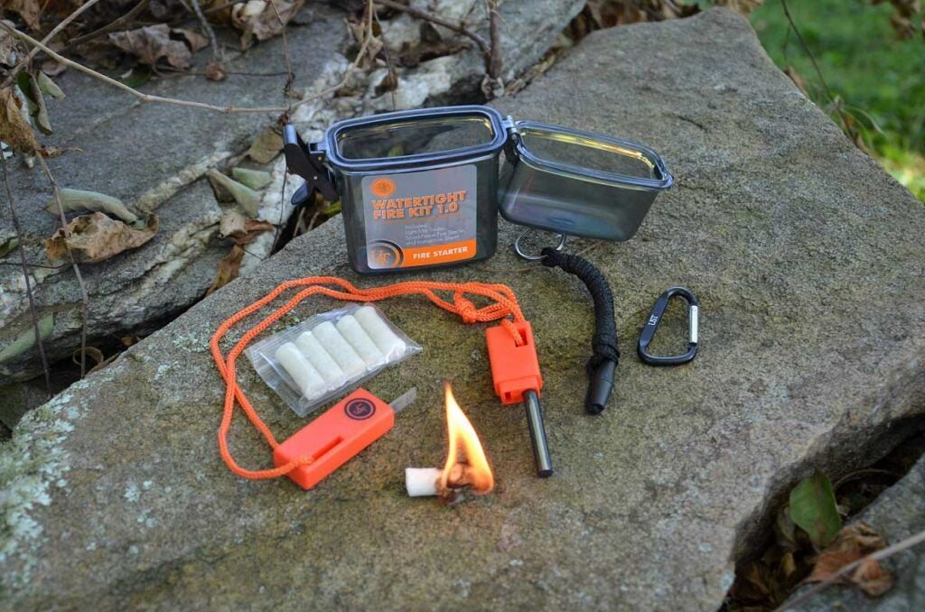 A fire-starting kit on a rock.