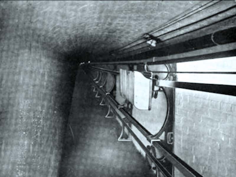 A black and white conveyor belt in a tunnel under the Capitol